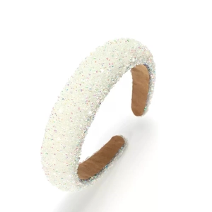 Detail of white sponge headband with shimmering rhinestones and non-slip brown lining
