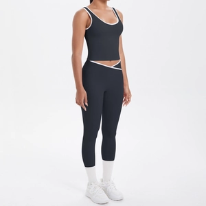 Detail of high-waisted yoga pants with V-cross waistband and white contrast piping accents