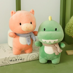Plush pink pig and green dinosaur toys wearing scarves, soft stuffed animals for kids