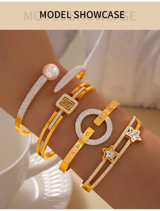Detail shot of four layered gold titanium bangles with pearls and star zircon motifs