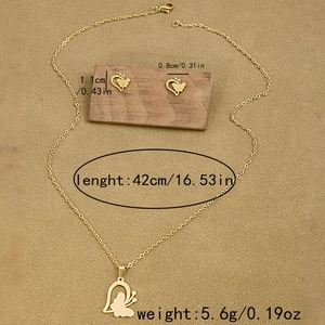 Close-up of gold heart butterfly pendant set with precise measurement annotations