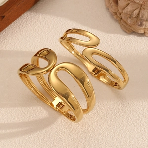 Polished 18k gold plated stainless steel spring cuff bracelet with hollow geometric design