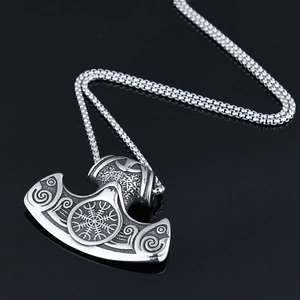 Macro view of Viking battle axe pendant with Nordic runes on polished steel
