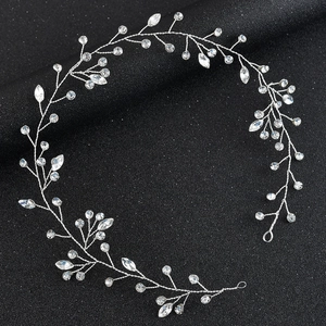 Silver bridal vine headband with marquise crystals on a black textured background
