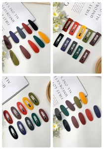 Macro shot of matte Morandi color BB hair clips with various geometric shapes on a white fabric