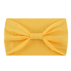 Elastic yellow knotted yoga headband made of soft stretchy fabric for sports
