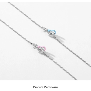 Macro detail of S925 sterling silver bow bracelets with blue and pink enamel accents