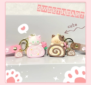 Detail of cute cat cake roll keychains with matching wristbands and gold metal rings