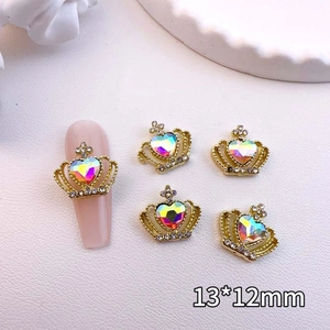 Macro shot of gold crown nail art charms with iridescent heart crystal measuring 13x12mm