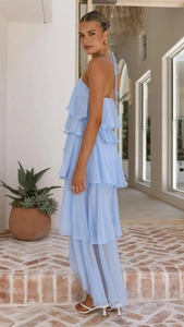 Detail of light blue tiered chiffon maxi dress with halter neck and ruffled skirt layers