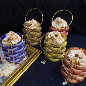 Macro detail of rhinestone birdcage evening bags in various metallic colors with satin liners