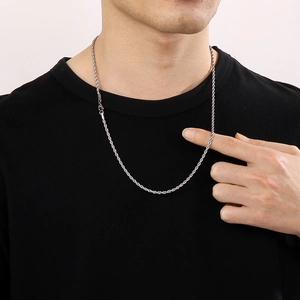 Detailed close-up of a silver 3mm twisted rope chain necklace worn by a male model