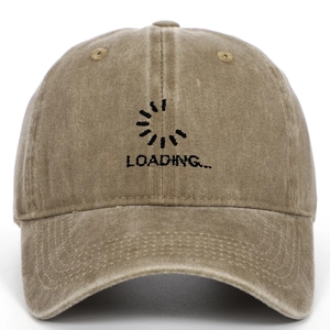Detailed view of the black 'LOADING...' embroidery on a vintage washed khaki cotton cap