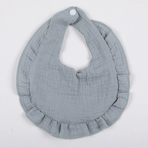 Macro detail of breathable double-layer gray gauze cotton baby bib with ruffle edges