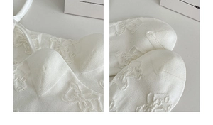 Detailed close-up of white knitted socks featuring embossed bear patterns and toe texture
