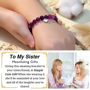 Detail of purple stone beaded bracelet with heart pendant shown as a meaningful sister gift