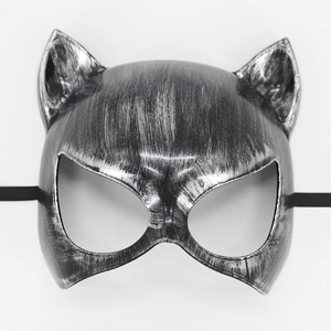 Detailed macro view of silver and black cat ear masquerade mask with brushed metal texture