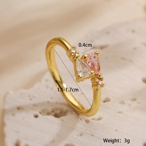 Macro shot of gold-plated open ring with pear-cut zircon stones and size dimensions