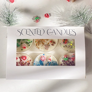 6-piece Christmas scented candle set with miniature festive charms in a window gift box