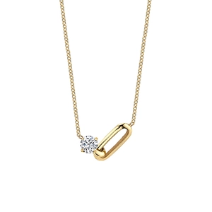 Macro shot of gold paperclip chain necklace with a sparkling round gemstone pendant