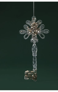 Detailed view of a transparent acrylic key ornament with gold glitter for Christmas decor