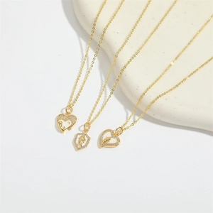 Elegant gold-plated necklaces with heart and shield pendants featuring white zircons