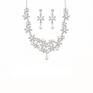 Exquisite flower jewelry set with pearl and diamond accents on a white background