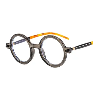 Retro round grey sunglasses with tortoiseshell temples and gold metal hinges