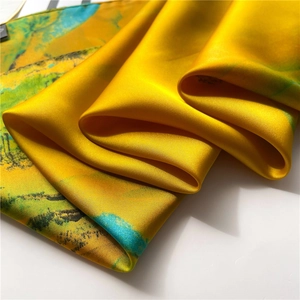 Golden silk scarf with landscape painting pattern featuring smooth satin texture