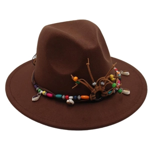 Detail of brown fedora hat with bohemian beaded band, tassels and natural shells