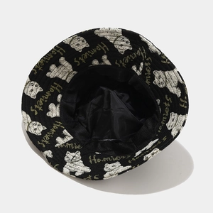 Black bucket hat with white dog pattern and green Homies embroidery for casual wear