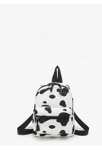 Close-up of cow print mini canvas backpack featuring dual zippers and front pocket