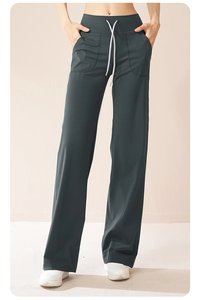 Detail of high waist yoga wide-leg pants with adjustable white drawstring and large side pockets