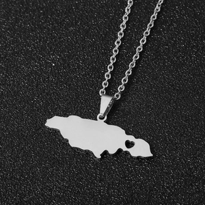 Macro detail of silver stainless steel Jamaica map pendant with heart cutout and chain