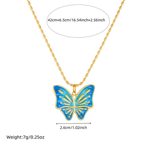 Golden snake chain necklace with blue and purple butterfly pendant on white background