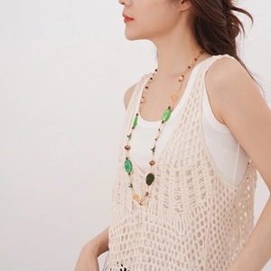 Bohemian beaded long necklace with green agate and shell charms on model