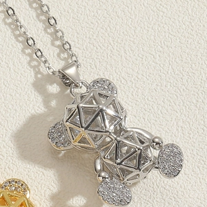 Macro shot of silver hollow bear pendant necklace with sparkling zircon pave details