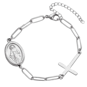 Macro shot of silver Virgin Mary oval medal and sideways cross charm on polished chain
