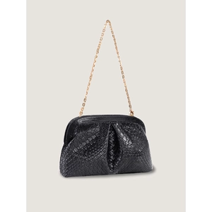 Close-up of black woven texture dumpling bag with gold chain and vintage metal frame clasp