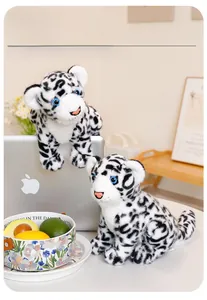 Detail showing plush snow leopard texture with realistic blue eyes in home setting