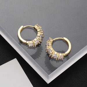 Detail of 18K gold plated hoop earrings with five sparkling cubic zirconia stones