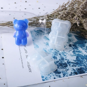 Detail of bear shaped silicone resin mold with a finished blue resin bear pendant