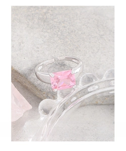Macro shot of 925 silver ring featuring a rectangular pink zircon on a textured stone