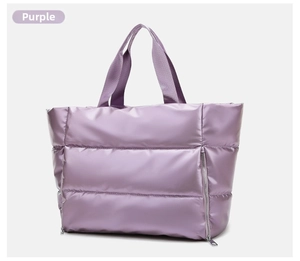 Detail of purple puffer tote bag with quilted texture and silver zipper pocket