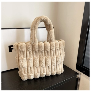 Detail showing the vertical quilted texture and soft plush material of the beige tote bag