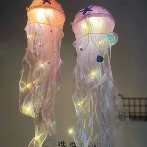 Detail of pink and purple jellyfish hanging lamps with starfish, lace and LED lights