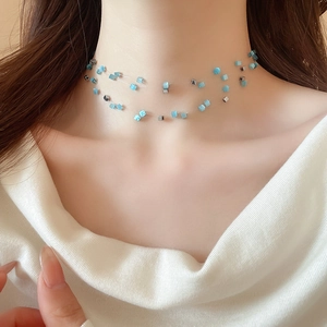 Close-up of double-layer choker with sky blue and silver square beads on invisible wire