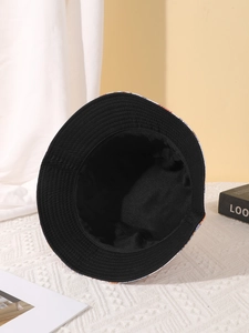 Detailed interior view of a wide-brimmed reversible bucket hat with black lining