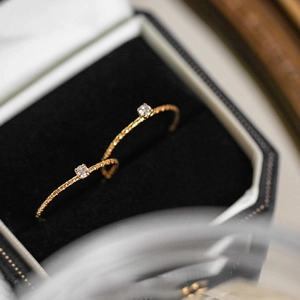 Detail of 18k gold plated twist hoops with micro-set zircon in a black velvet box