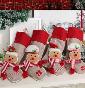Set of four burlap Christmas gingerbread man stockings displayed on a white mantel